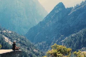 Woman Practicing Meditation in Mountains
